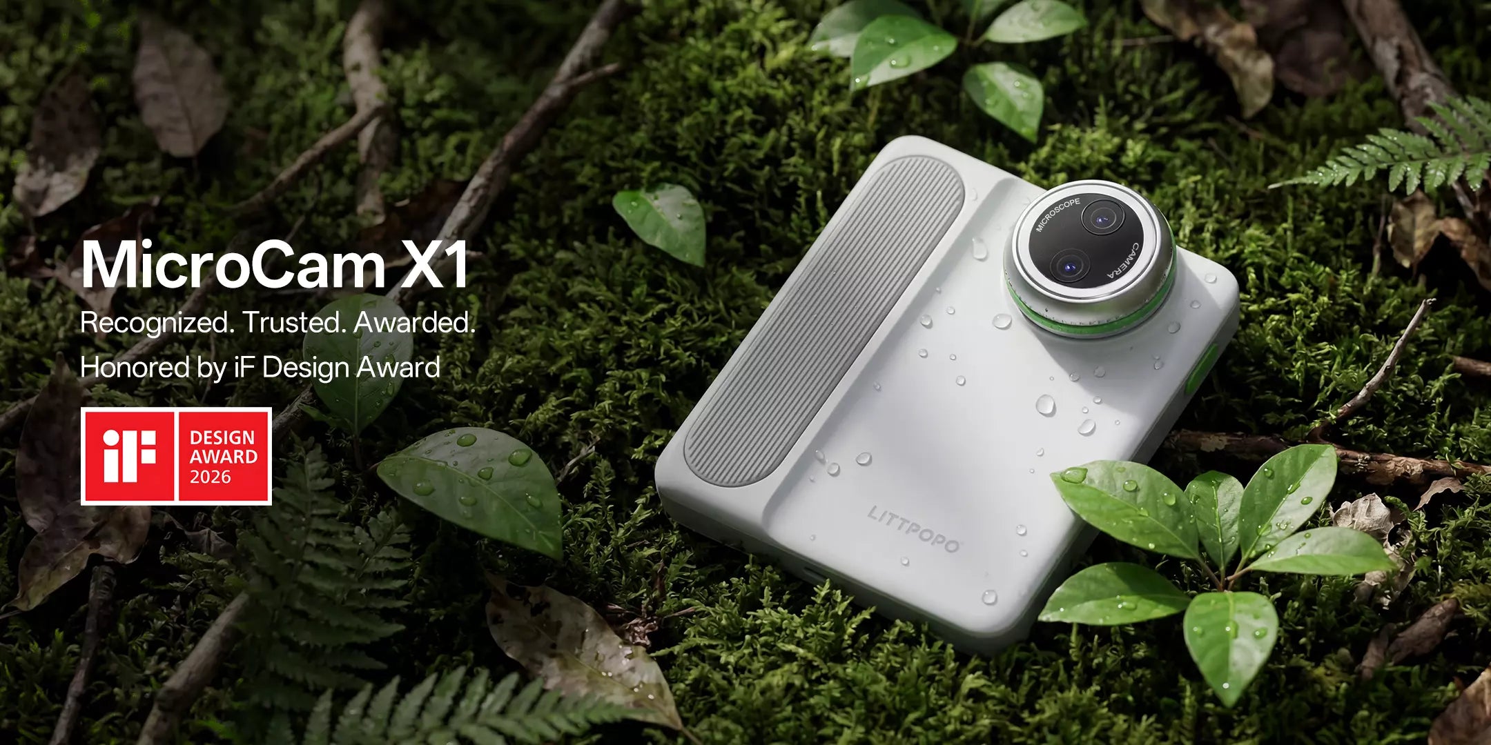 Rugged Littpopo MicroCam X1 digital microscope designed for field use, resting on a forest floor covered in moss, ferns, and water-droplet-covered leaves